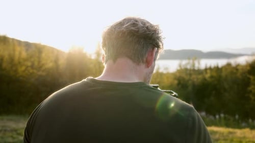 Man Filming Nature at Sunset