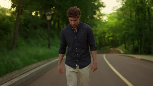 Man walking in green park area during daytime