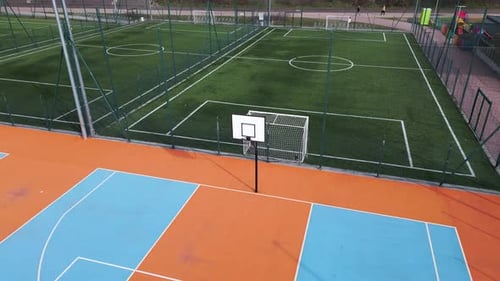 Aerial View of Outdoor Basketball and Soccer Courts with Vibrant Blue Orange and Green Colors The