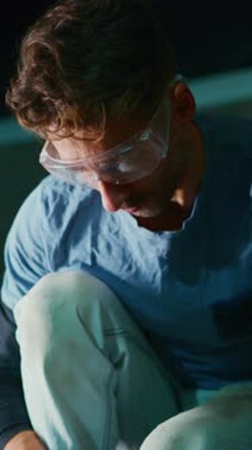 Focused Craftsman Working on a Project Carefully Measuring Materials While Wearing Protective