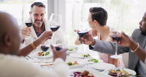 Friends Toasting Wine Glasses at Celebration Meal