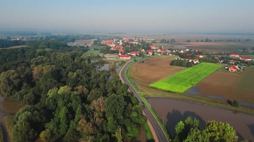 Aerial View of Flooded Rural Landscape Near Forest and Residential Area