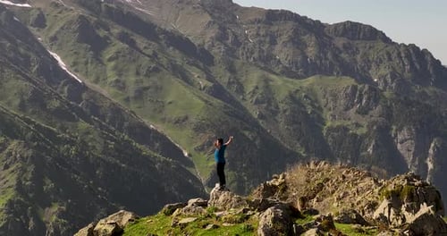 a person with open hands on a hill