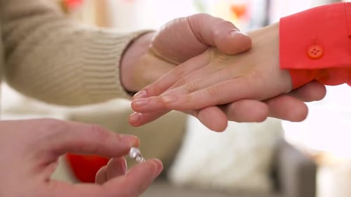 Valentines Day, Proposal and Engagement Concept - Man Putting Diamond Ring To