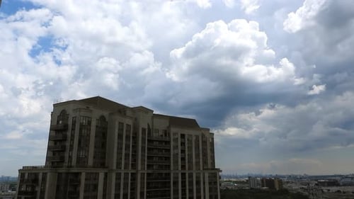 Highrise hotel building exterior. Timelapse with clouds moving, establishing shot
