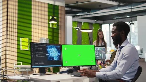 Software Developer Using AI on Green Screen Computer to Optimize Performance