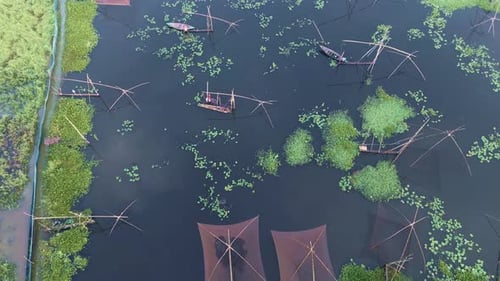 Tranquil Waterway with Traditional Fishing Nets and Boats