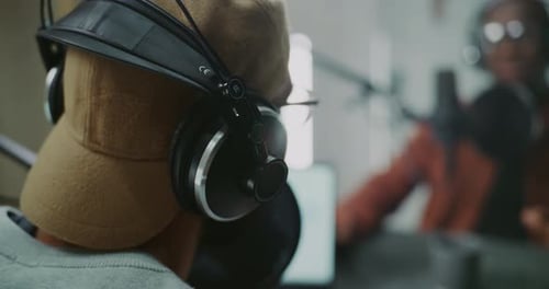 Podcast Host Wearing Professional Headphones With Tattoo on Neck
