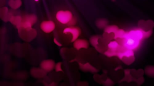 Seamless loop background with valentines hearts flying against light on black