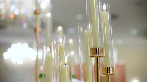 Shot of Served Table with Cozy Candles As a Part of Decoration at the Party in Restaurant Wedding