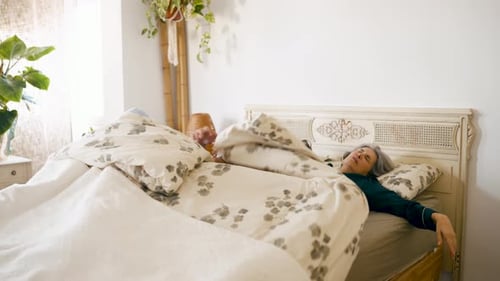Senior Couple Waking Up in the Morning in Their Bed