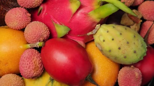 Exotic fruit in the plate rotation. Fresh tropical fruits rotate, close-up. Tropical Fruit