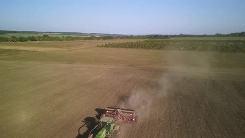 Tractor on the field seeding wheat