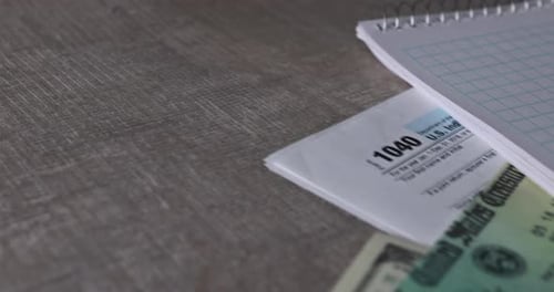 Tax Form, Refund Check, and One Hundred Dollar Bills