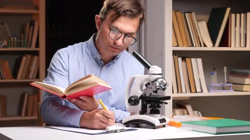 Científico leyendo un libro y estudiando con un microscopio en una biblioteca