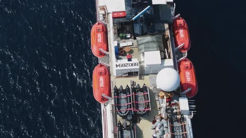 Aerial view of a vessel deck with red lifeboats, Maldives.