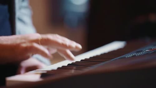 Man Playing Piano Keys Close Up