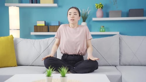 Woman Meditating on Sofa in Bright Living Room