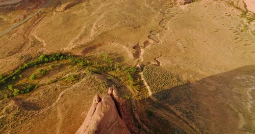Little greenery growing in the desert landscape. Drone footage over beautiful canyons of Utah, USA.