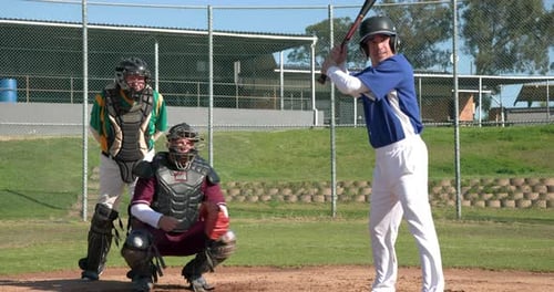 Baseball Batter Swinging Bat on Baseball Field