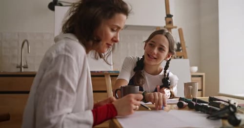 A Girl Clarifies and Asks Questions About Drawing to Her Teacher While They are Doing Art Lessons at