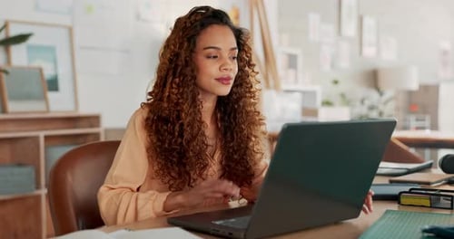 Young Woman Working on Laptop at Home Office