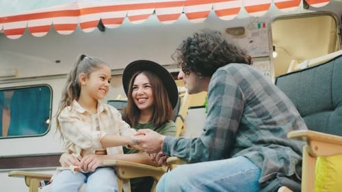 Family Laughing Together at Campsite Trailer