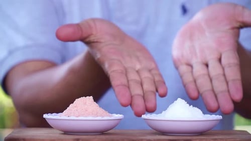 Two Bowls of Salt Presented on Wood