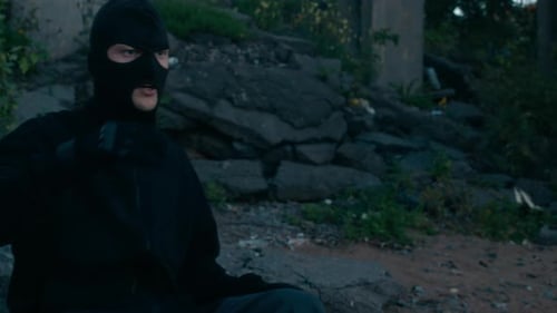 Criminal Taking off Balaclava Outdoors
