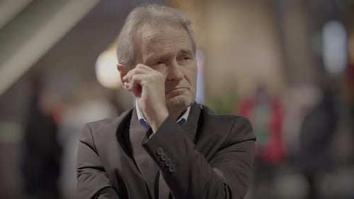 Thoughtful Man in Suit Ponders Urban Scene