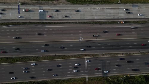 Rush hour traffic on busy urban city highway with multi-lane roads and vehicles