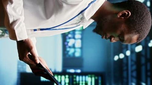 Young Adult Examining Smartphone in High Tech Facility