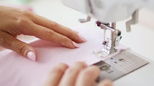 Woman Using Sewing Machine for Fashion Project