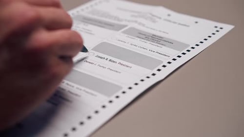 Close Up in the Presidential Election an American Sample Ballot a Hand with a Pen Makes a Choice