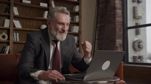 Joyful Businessman Celebrating Success in Office