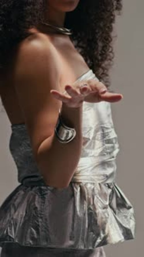 Woman in Silver Dress Posing Elegantly
