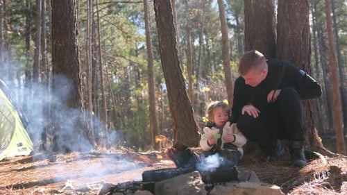 Family Moments Around a Cozy Campfire in a Quiet Forest Setting