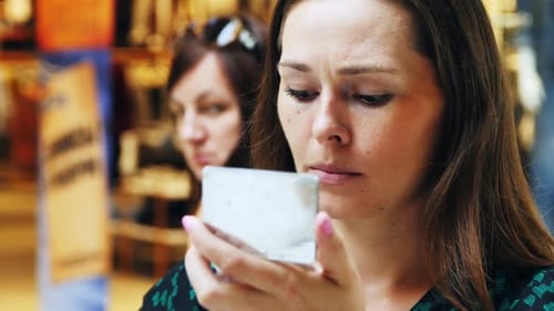 Woman Applying Lipstick in Mirror at Store