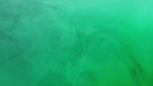 Green Ink Acrylic Paint Mixing in Water Swirling Softly Underwater in Aquarium