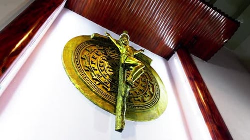 Golden Religious Statue on Wall in Building