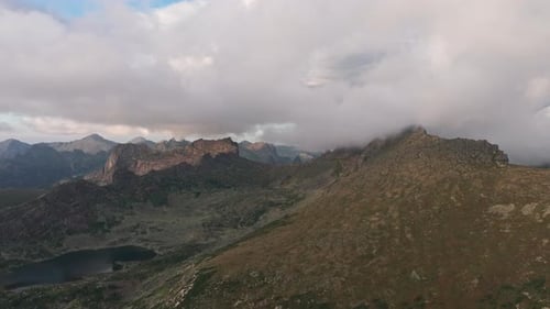 Clouds Embracing Mountain Peaks in a Cloudy Landscape