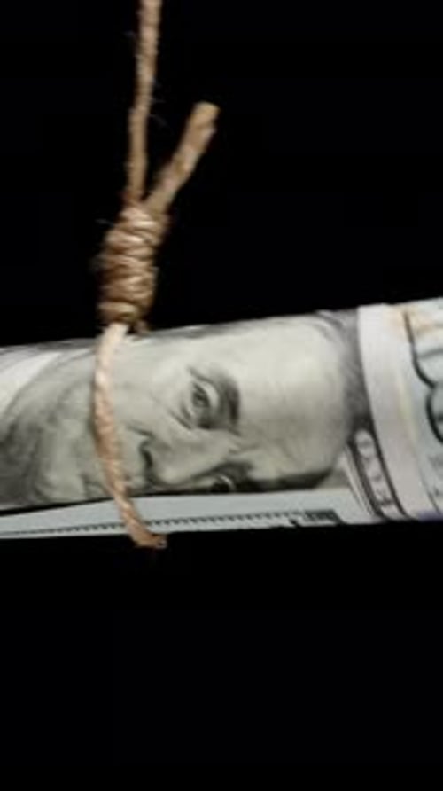 Vertical video. A Twisted Hundred-Dollar Bill Hanging On A Rope In A Tight Noose, Freedom Or