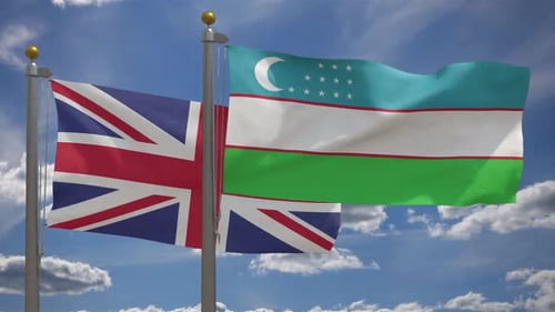 Flags of United Kingdom and Uzbekistan Waving on Flagpoles Against Blue Sky
