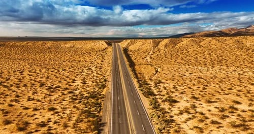Footage above the highways in Nevada desert, USA. Gorgeous cloudscape in the sky at backdrop.