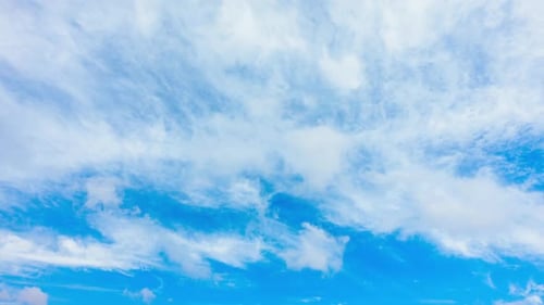 Blue Sky with White Clouds. Puffy Fluffy White Clouds Moving Fast. Cumulus Cloudscape Timelapse