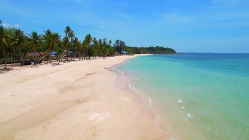 The coconut tree-lined sandy beach with its stunning turquoise waters