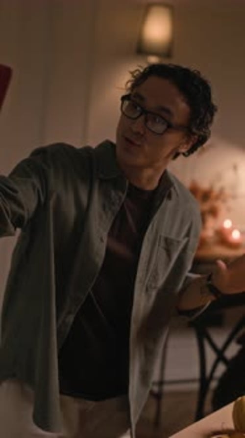 Friends Waving During a Video Call at Dinner