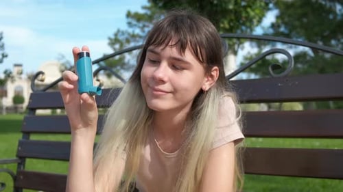 Resting in Park with Asthma Inhaler