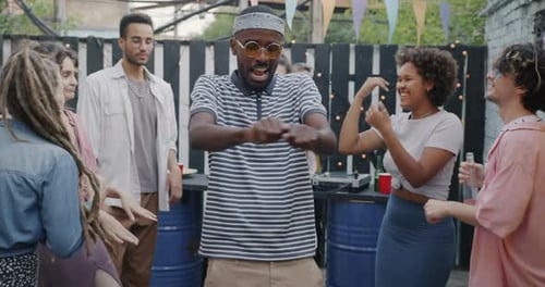 Slow Motion Portrait of Happy African American Man Student Dancing at Terrace Party Enjoying Leisure