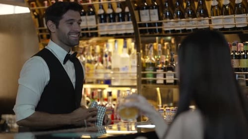 Bartender and customer at night club.